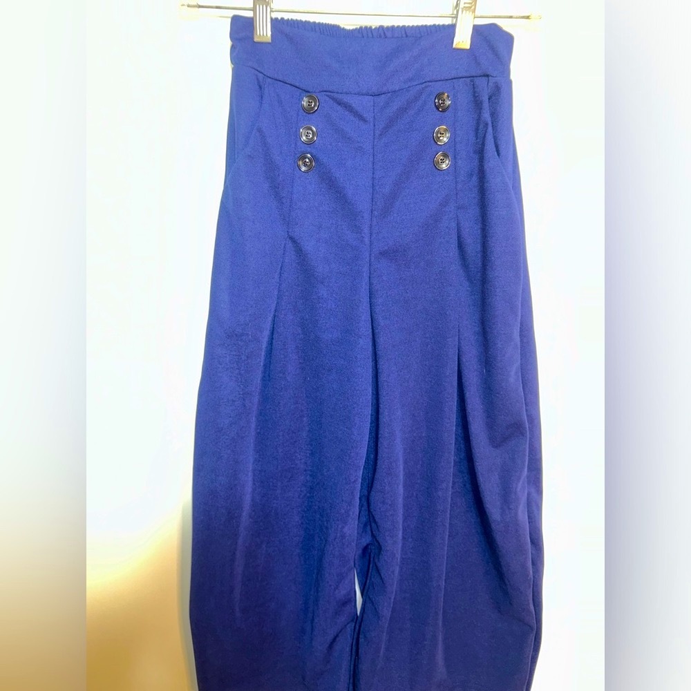 Dark blue wide-leg pants with black button details around the waist